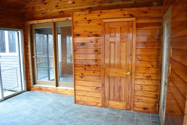 interior space with wooden walls and vaulted ceiling