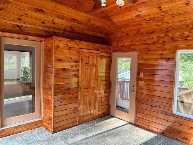 entryway featuring wood walls, plenty of natural light, wooden ceiling, and vaulted ceiling