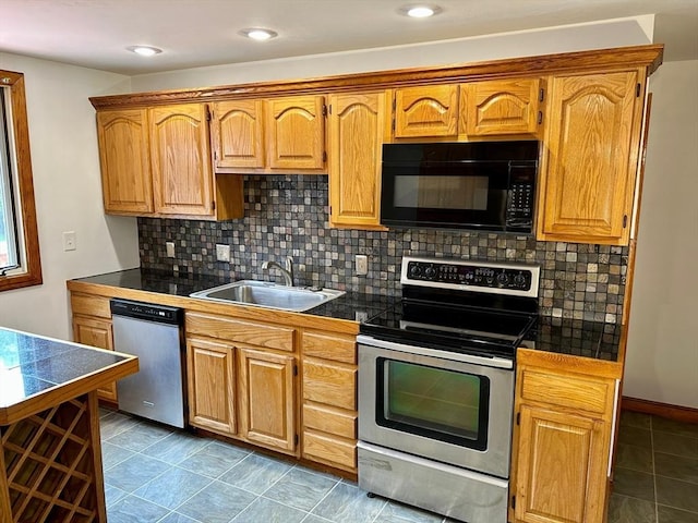 kitchen featuring backsplash, stainless steel appliances, and sink