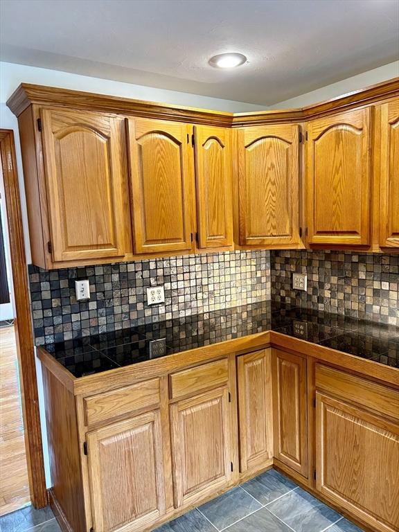 kitchen with tasteful backsplash and tile counters