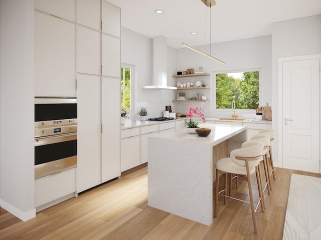 2-18 Elm St Unit 18, Newton, MA 02465 - kitchen featuring oven, light wood-style flooring, a sink, white cabinets, and recessed lighting