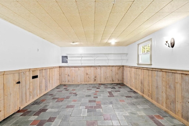 interior space with wooden walls and wainscoting