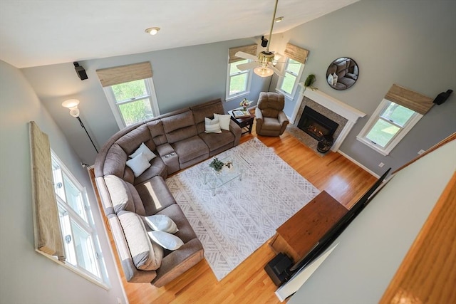 70 Huntsbridge Rd, North Attleboro, MA 02760 - living room with plenty of natural light, a ceiling fan, a warm lit fireplace, wood finished floors, and vaulted ceiling