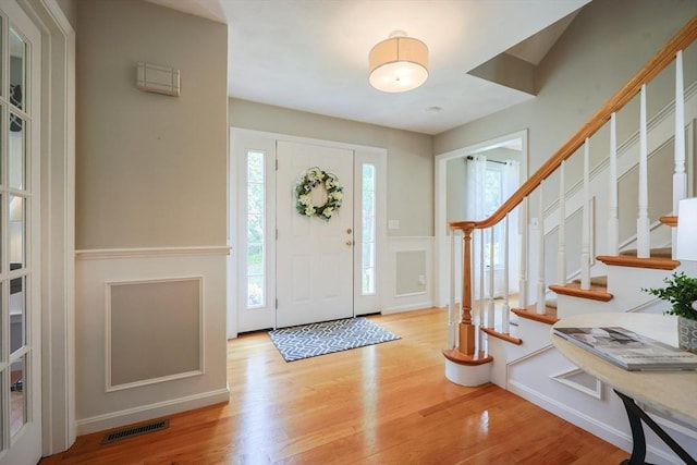 70 Huntsbridge Rd, North Attleboro, MA 02760 - entryway with wood finished floors, stairway, a decorative wall, and a wainscoted wall