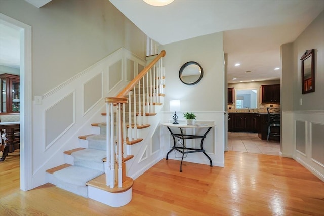 70 Huntsbridge Rd, North Attleboro, MA 02760 - staircase with a decorative wall, wood finished floors, and wainscoting