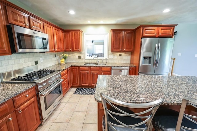 70 Huntsbridge Rd, North Attleboro, MA 02760 - kitchen with appliances with stainless steel finishes, backsplash, light tile patterned flooring, dark stone countertops, and recessed lighting