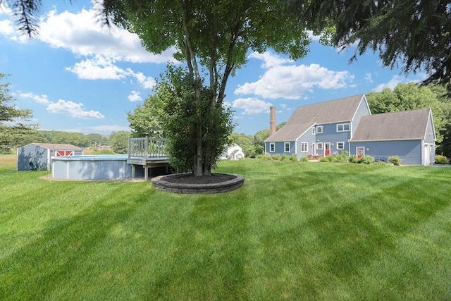70 Huntsbridge Rd, North Attleboro, MA 02760 - view of green lawn with an outdoor pool and a wooden deck