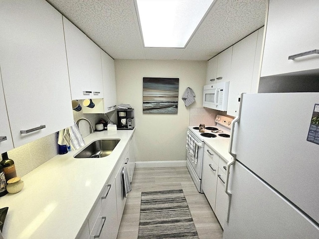 5056 Broadlawn Park Unit 509, Boston, MA 02467 - kitchen featuring a sink, light countertops, light wood-type flooring, and white appliances
