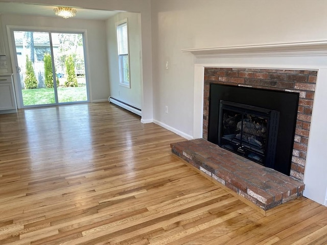 unfurnished living room with baseboards, baseboard heating, a brick fireplace, and wood finished floors