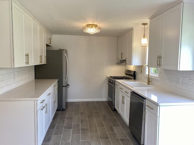 kitchen with a sink, white cabinetry, appliances with stainless steel finishes, and tasteful backsplash
