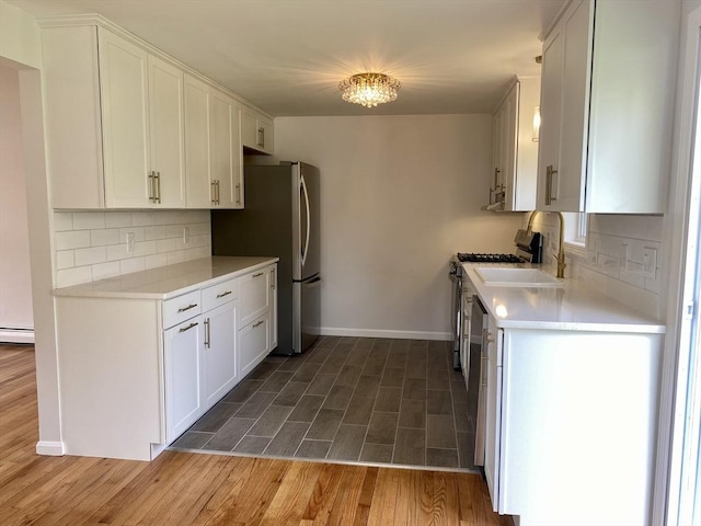 kitchen with baseboards, decorative backsplash, and wood finished floors