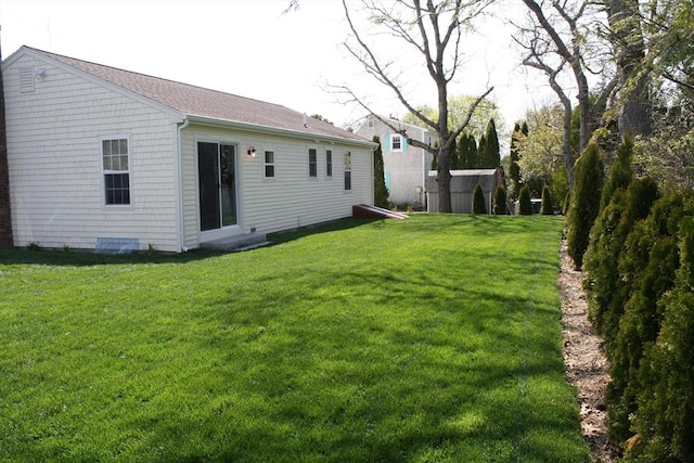 back of property featuring a lawn