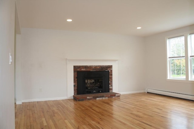 unfurnished living room featuring baseboards, recessed lighting, wood finished floors, and baseboard heating