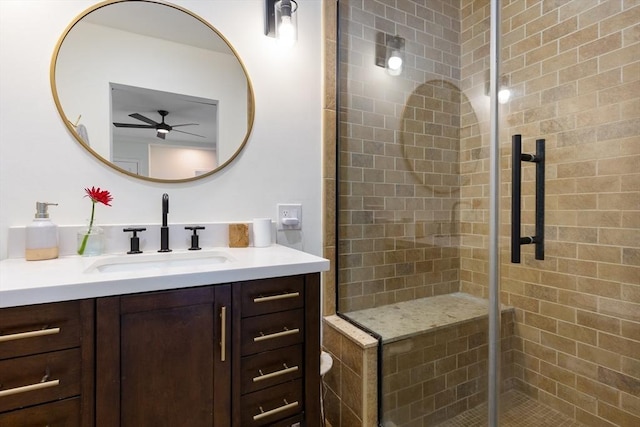 bathroom with vanity, ceiling fan, and a shower stall