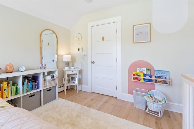 rec room featuring baseboards, wood finished floors, and lofted ceiling