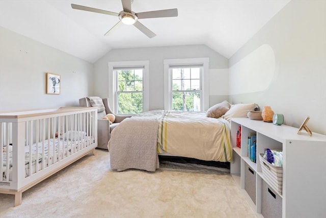 carpeted bedroom featuring a ceiling fan and lofted ceiling