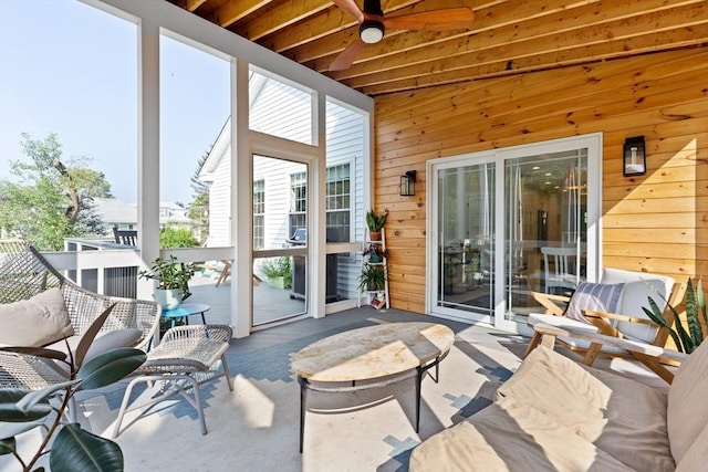 sunroom featuring a ceiling fan