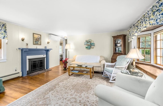 68 Fifth Ave, Barnstable, MA 02601 - living room featuring a wall mounted AC, wood finished floors, a baseboard heating unit, a fireplace with flush hearth, and a decorative wall
