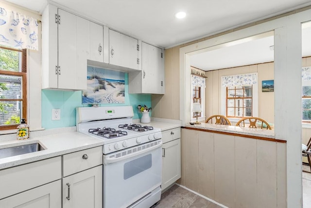 68 Fifth Ave, Barnstable, MA 02601 - kitchen featuring gas range gas stove, light countertops, white cabinets, plenty of natural light, and recessed lighting