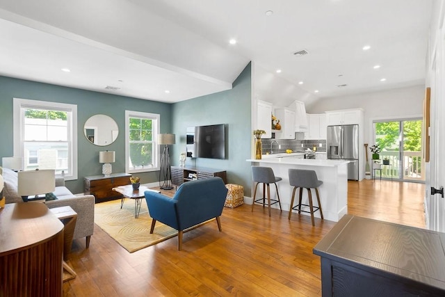 34 Alpha Rd Unit 3, Boston, MA 02124 - living area with light wood finished floors, vaulted ceiling, and recessed lighting