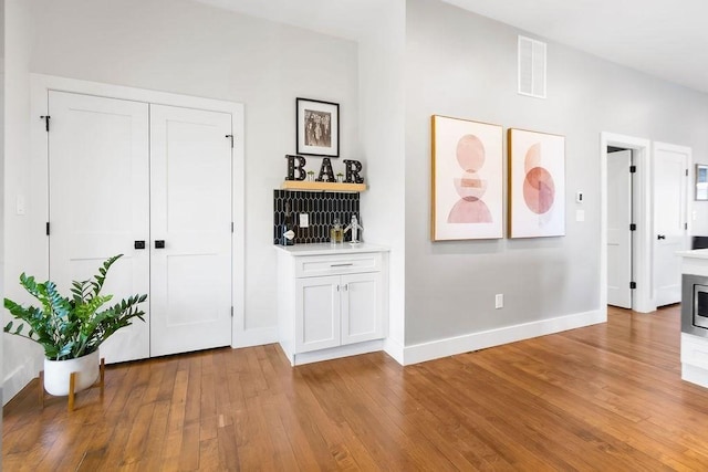 34 Alpha Rd Unit 3, Boston, MA 02124 - foyer with light wood-type flooring, baseboards, and bar