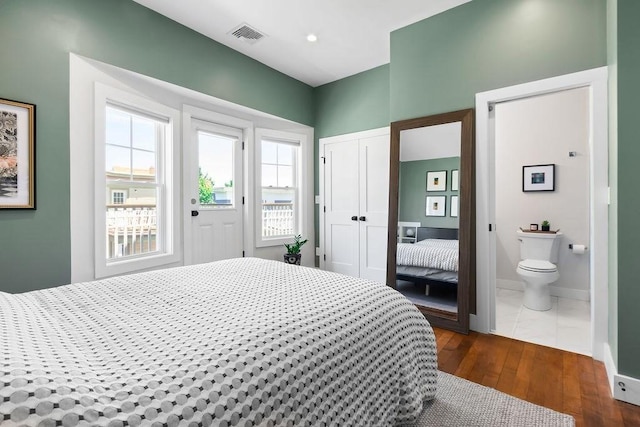 34 Alpha Rd Unit 3, Boston, MA 02124 - bedroom featuring multiple windows, a closet, dark wood-style floors, and ensuite bathroom
