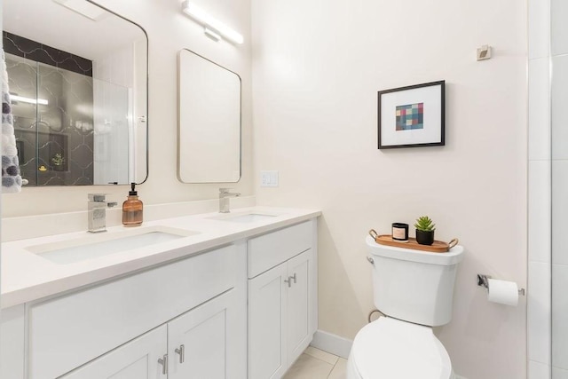 34 Alpha Rd Unit 3, Boston, MA 02124 - bathroom featuring toilet, double vanity, baseboards, tile patterned flooring, and a shower