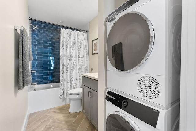 34 Alpha Rd Unit 3, Boston, MA 02124 - full bathroom with stacked washer / dryer, shower / tub combo, vanity, toilet, and wood finish floors