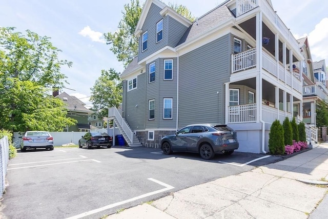 34 Alpha Rd Unit 3, Boston, MA 02124 - view of building exterior with stairs and uncovered parking