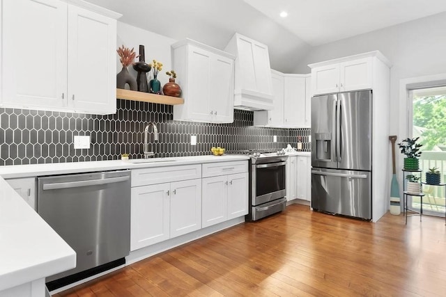 34 Alpha Rd Unit 3, Boston, MA 02124 - kitchen featuring stainless steel appliances, a sink, light countertops, white cabinetry, and vaulted ceiling