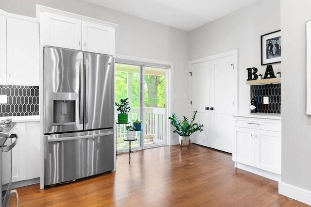 34 Alpha Rd Unit 3, Boston, MA 02124 - kitchen featuring stainless steel appliances, light countertops, wood finished floors, white cabinetry, and backsplash