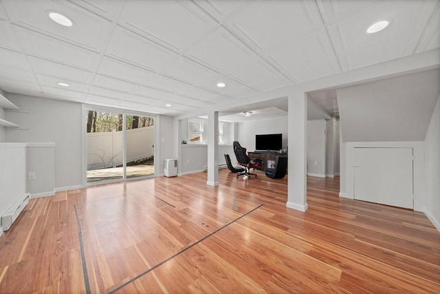 unfurnished living room featuring a baseboard radiator, light wood-type flooring, and recessed lighting