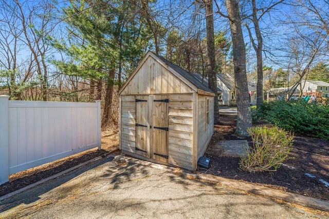 view of shed featuring fence