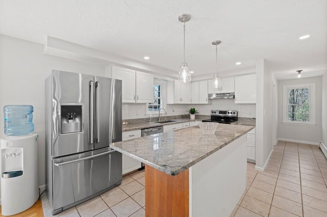 kitchen featuring white cabinets, a sink, appliances with stainless steel finishes, under cabinet range hood, and light tile patterned floors