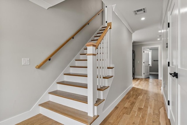 1 Wall St, Quincy, MA 02169 - stairs featuring ornamental molding, wood finished floors, recessed lighting, and stacked washer / dryer