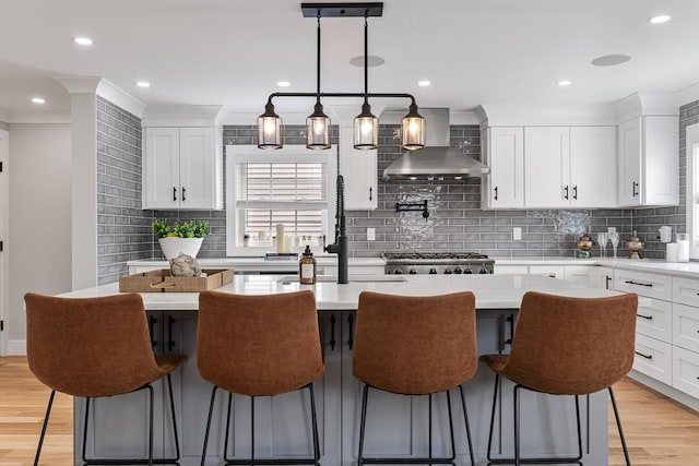 1 Wall St, Quincy, MA 02169 - kitchen featuring wall chimney exhaust hood, a center island, tasteful backsplash, light countertops, and recessed lighting