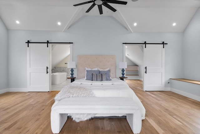 1 Wall St, Quincy, MA 02169 - bedroom featuring a barn door, light wood-style flooring, and a ceiling fan