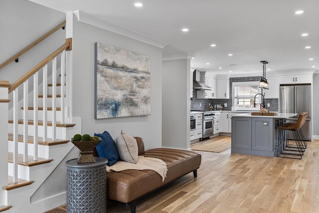 1 Wall St, Quincy, MA 02169 - living area featuring recessed lighting, light wood finished floors, stairway, and ornamental molding