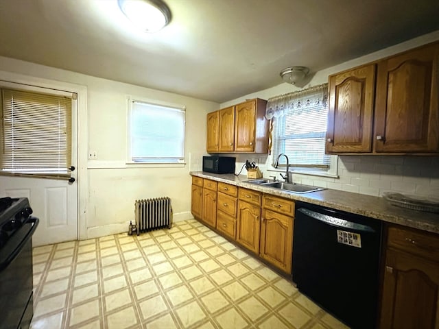 kitchen with black appliances, sink, radiator, and tasteful backsplash