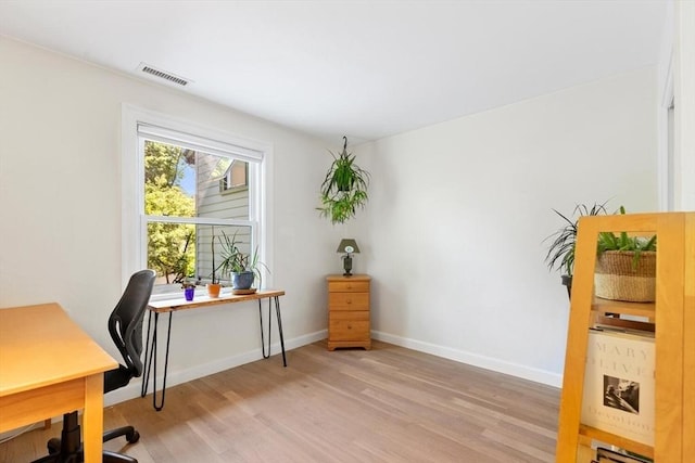 office with light wood-style floors and baseboards