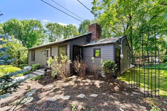 view of front of property with a chimney and a front yard