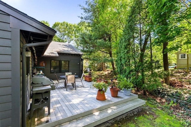 wooden deck featuring outdoor dining area