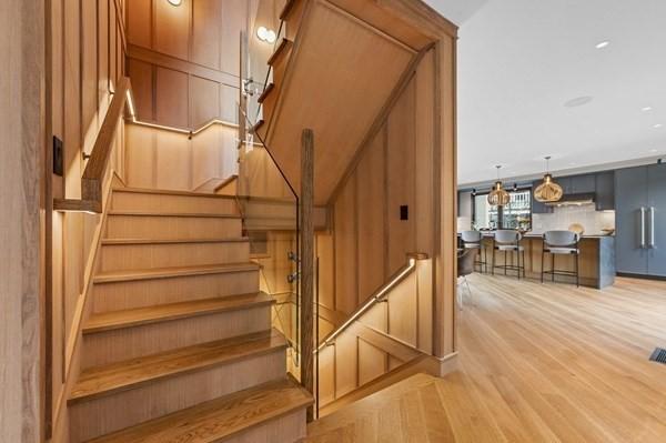 staircase featuring visible vents and wood finished floors