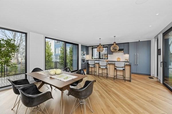 dining space featuring light wood finished floors and floor to ceiling windows