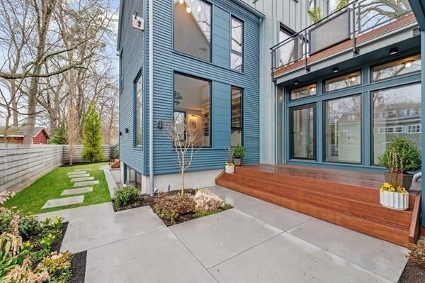 entrance to property featuring board and batten siding and fence