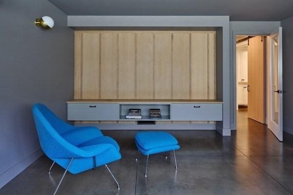 home office featuring finished concrete flooring and baseboards