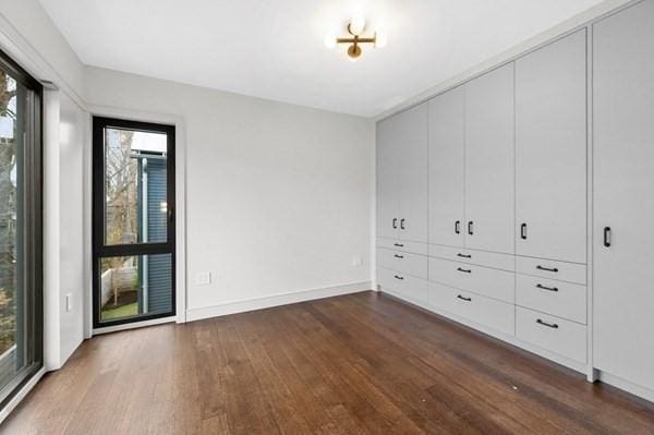 unfurnished room featuring baseboards and wood finished floors