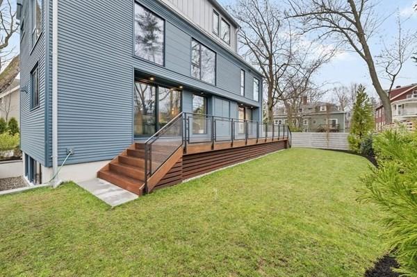 rear view of house featuring board and batten siding and a yard