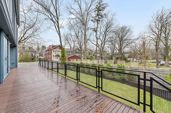 deck with a residential view and a yard