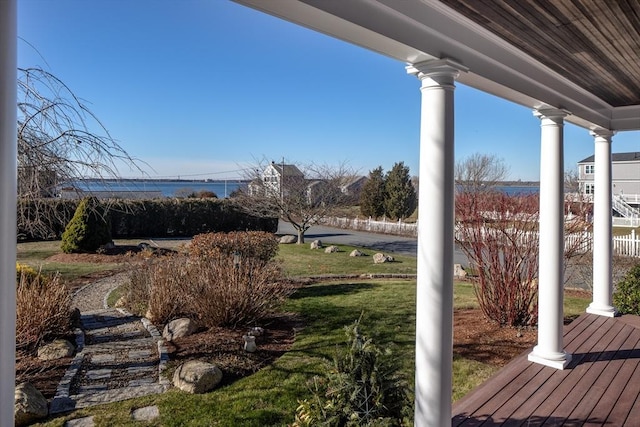 view of yard featuring covered porch and a water view